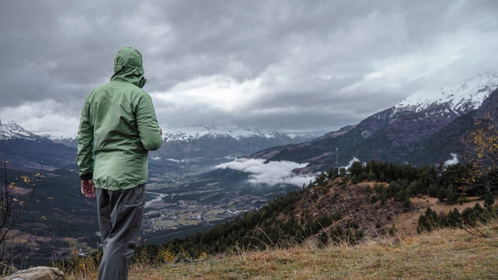 A man facing stormy mountains representing the uncertainty of washington state's new LTC tax
